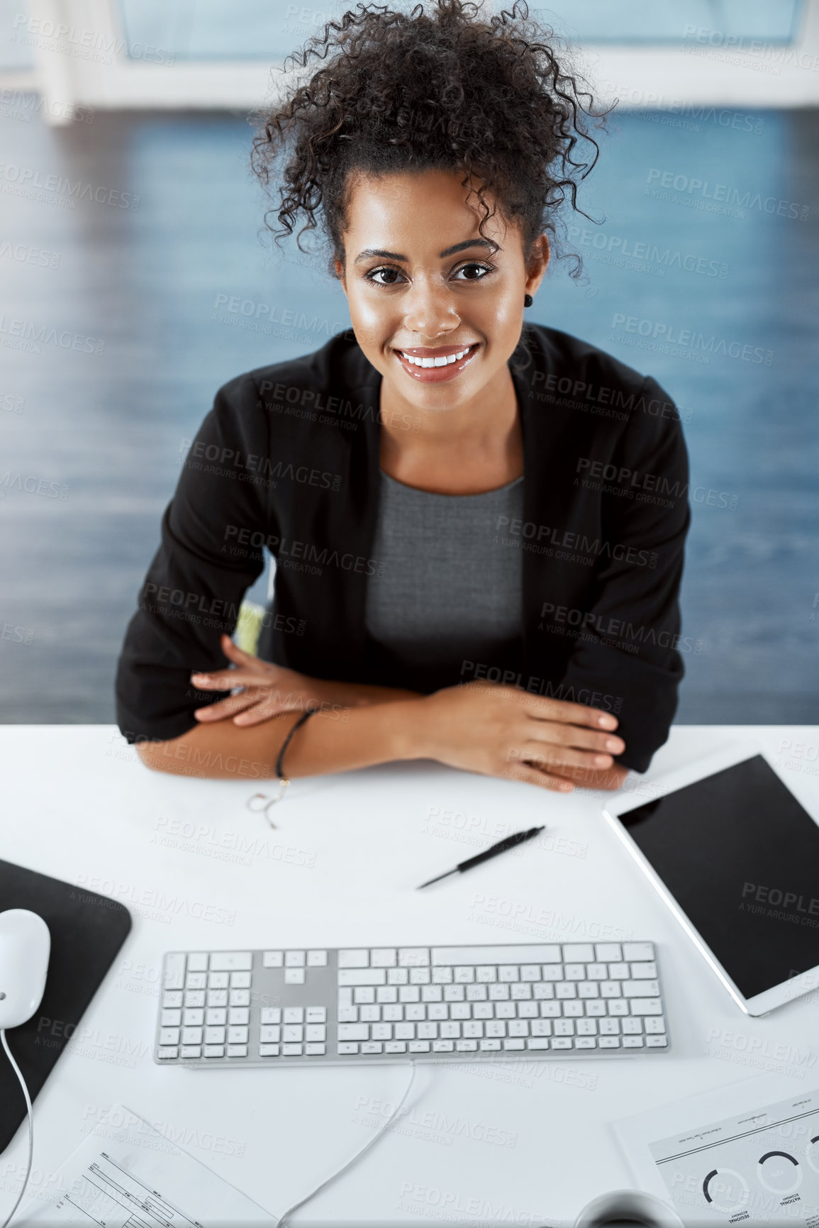 Buy stock photo High angle portrait of a young businesswoman working at her desk in a modern office
