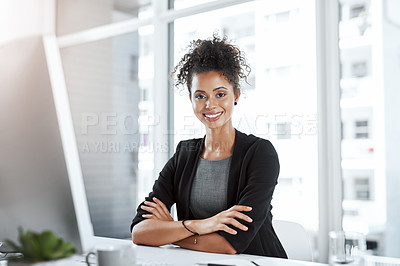 Buy stock photo Portrait of a young businesswoman working at her desk in a modern office