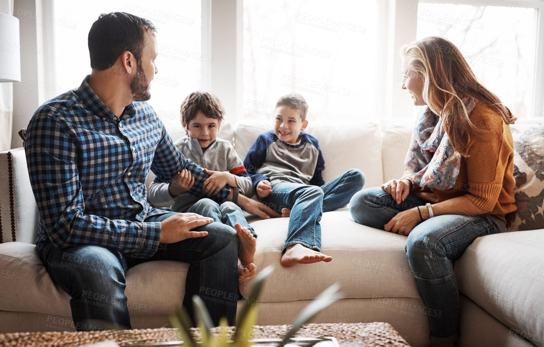 Buy stock photo Family home, boy kids and parents on sofa with conversation, love or bonding for childhood development. Happy family, relax and sitting together in home living room for fun, happiness or quality time