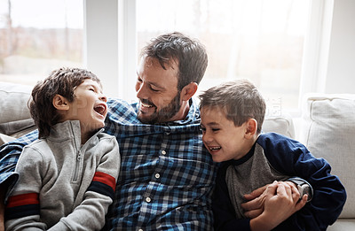 Buy stock photo Shot of two adorable little boys having fun with their father at home