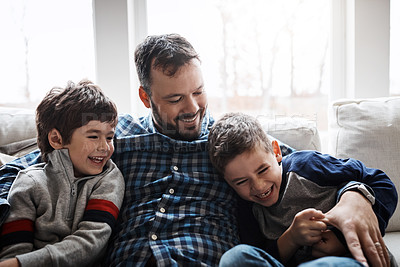 Buy stock photo Bonding, hug and father with children on the sofa for love, care and relax in their family home. Happy, funny and dad with boy kids for quality time, affection and comedy on the couch of a house