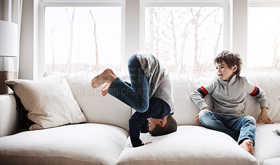 Buy stock photo Shot of two adorable brothers playing together on the sofa at home