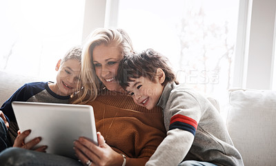 Buy stock photo Love, brothers and mother with tablet, sofa and connection for social media, funny videos and bonding in lounge. Boys, motherhood and mama with device, online reading and learning in living room 