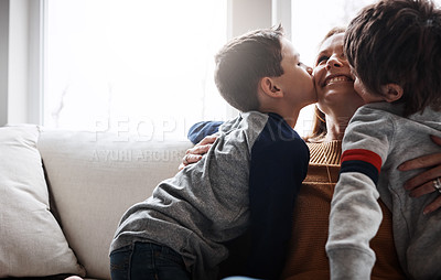 Buy stock photo Love, kiss and children with mom on a sofa for happy mothers day, gratitude and bonding in their home together. Family, hug and kid siblings with woman in a living room for support, trust or safety