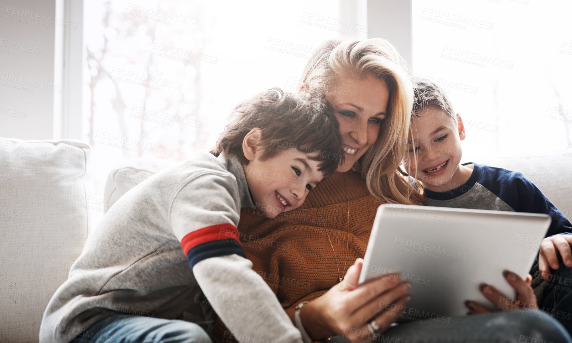 Buy stock photo Relax, tablet and mom with children on sofa bonding, quality time and streaming movies on weekend. Love, family home and mom and kids with digital tech for online games, learning and internet app