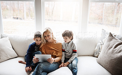 Buy stock photo Tablet, home and mother with children on sofa bonding, quality time and relax on weekend together. Love, family and mom and kids with digital tech for online games, streaming movies and internet app