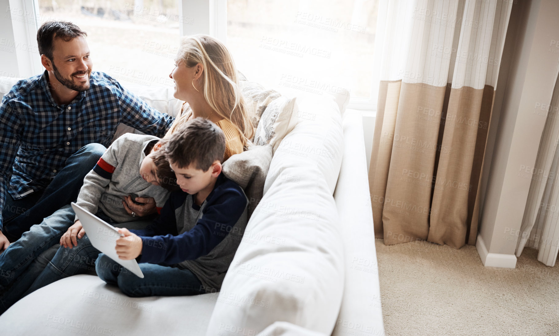 Buy stock photo Family, sofa and boy siblings with tablet, mom and dad in happy conversation in home living room. Happy family together, couch and kids with mobile touchscreen tech for learning, gaming or bonding