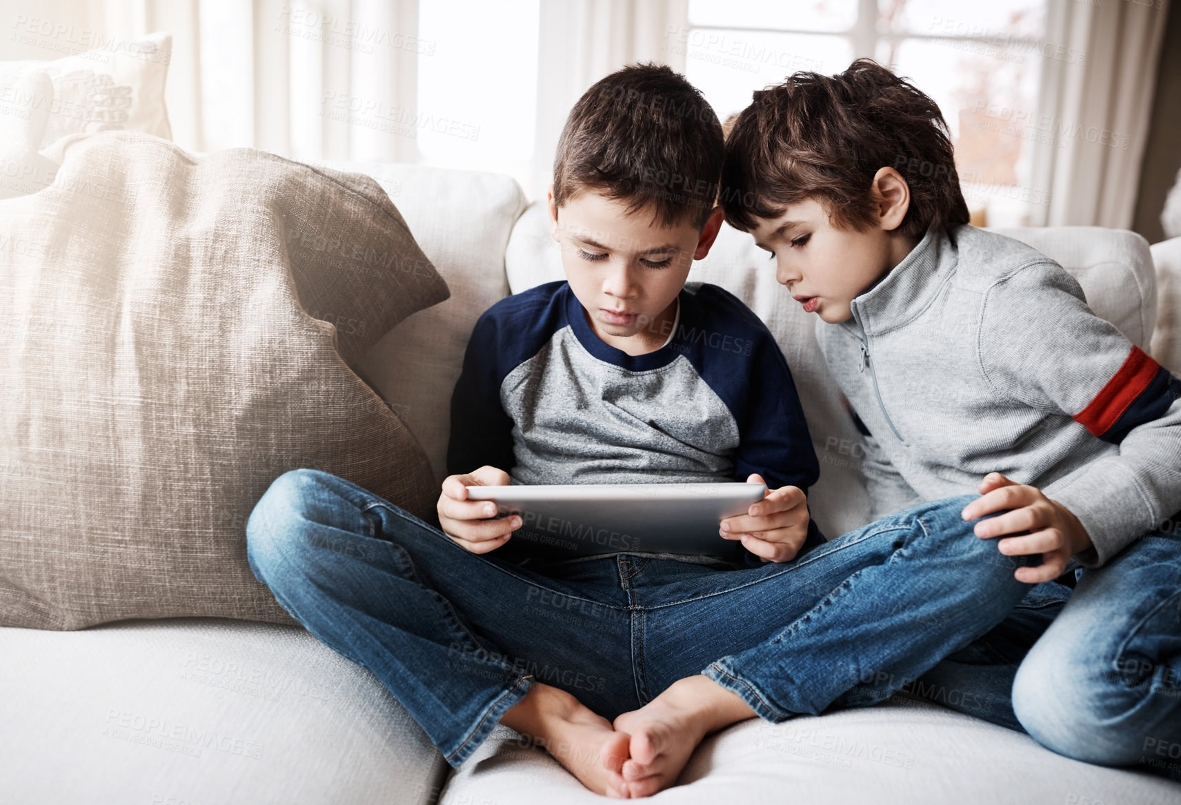 Buy stock photo Sibling boys, tablet and couch for games, relax and digital app for learning, web streaming or movie. Kids, sofa and mobile tech on social media, education or video for development, reading or gaming