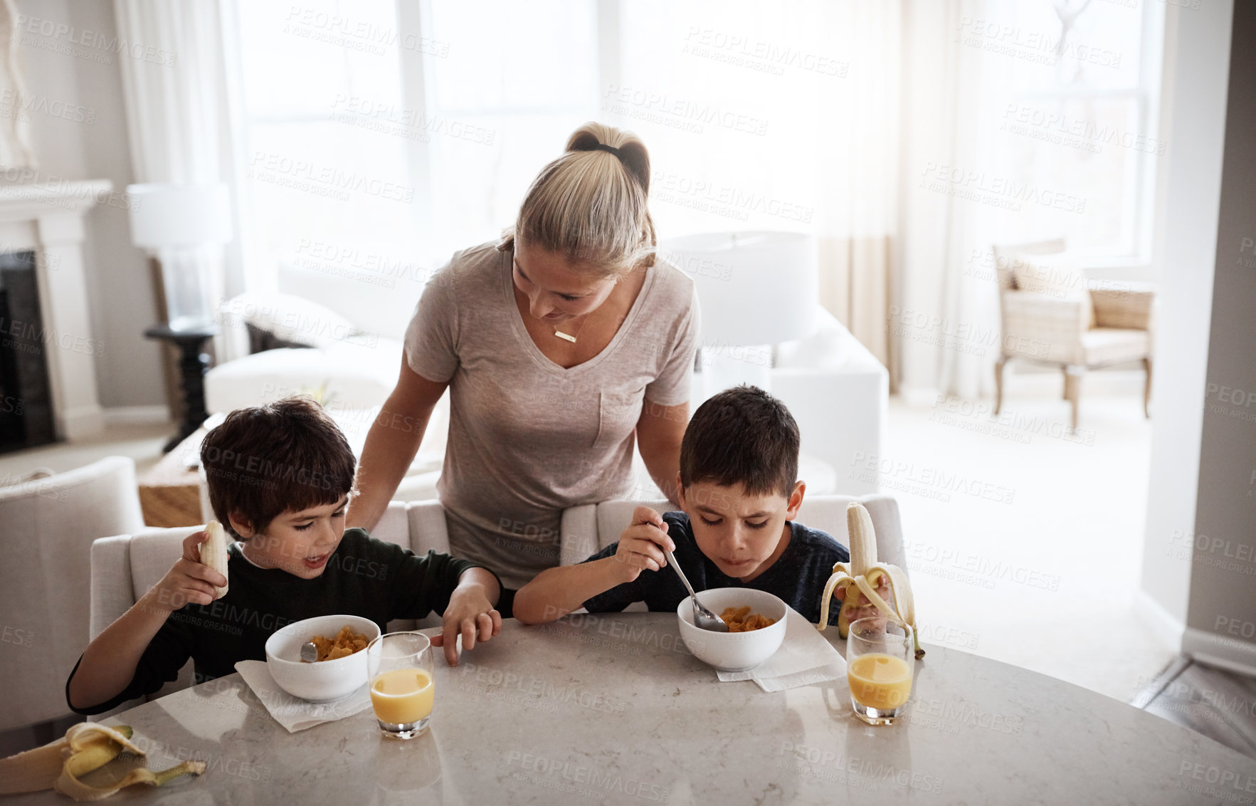Buy stock photo Eating, happy and mother with children for breakfast nutrition and food in the morning. Hungry, together and boy kids with fruit, juice and love from mom during a snack or lunch at the table