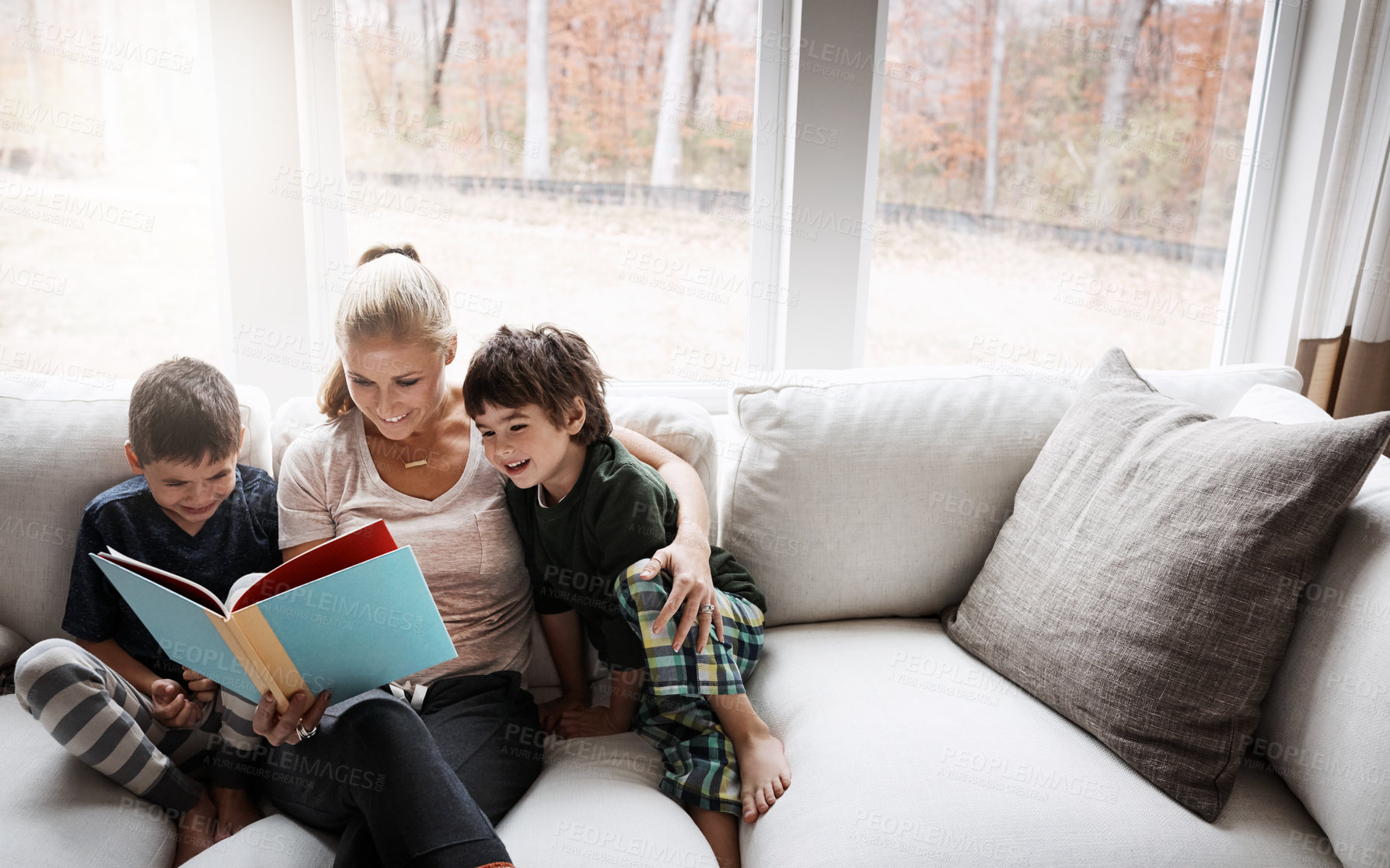 Buy stock photo Books, reading and mother with kids on sofa for storytelling time in living room of happy home. Love, learning and woman with children, book and fantasy story on couch, growth and child development.