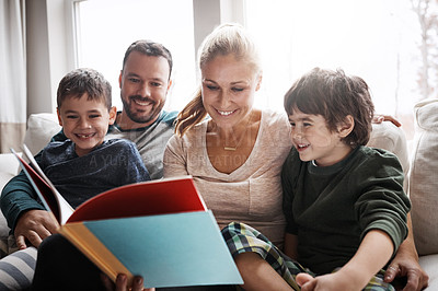 Buy stock photo Family, couple and children on sofa for storytelling time with books and learning in family home. Love, reading and children, mother and father with fantasy book on couch, smile and fun in apartment.