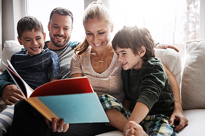 Buy stock photo Mom, dad and kids reading book on sofa, storytelling time in living room of happy family home. Love, learning to read and couple with children, book and fantasy story on couch together on weekend.