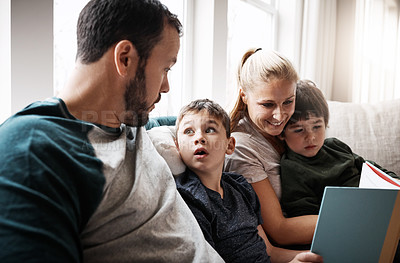 Buy stock photo Man, woman and kids on sofa with book learning to read at storytelling time in living room of home. Love, family and couple with children, books and child development on couch in apartment together.