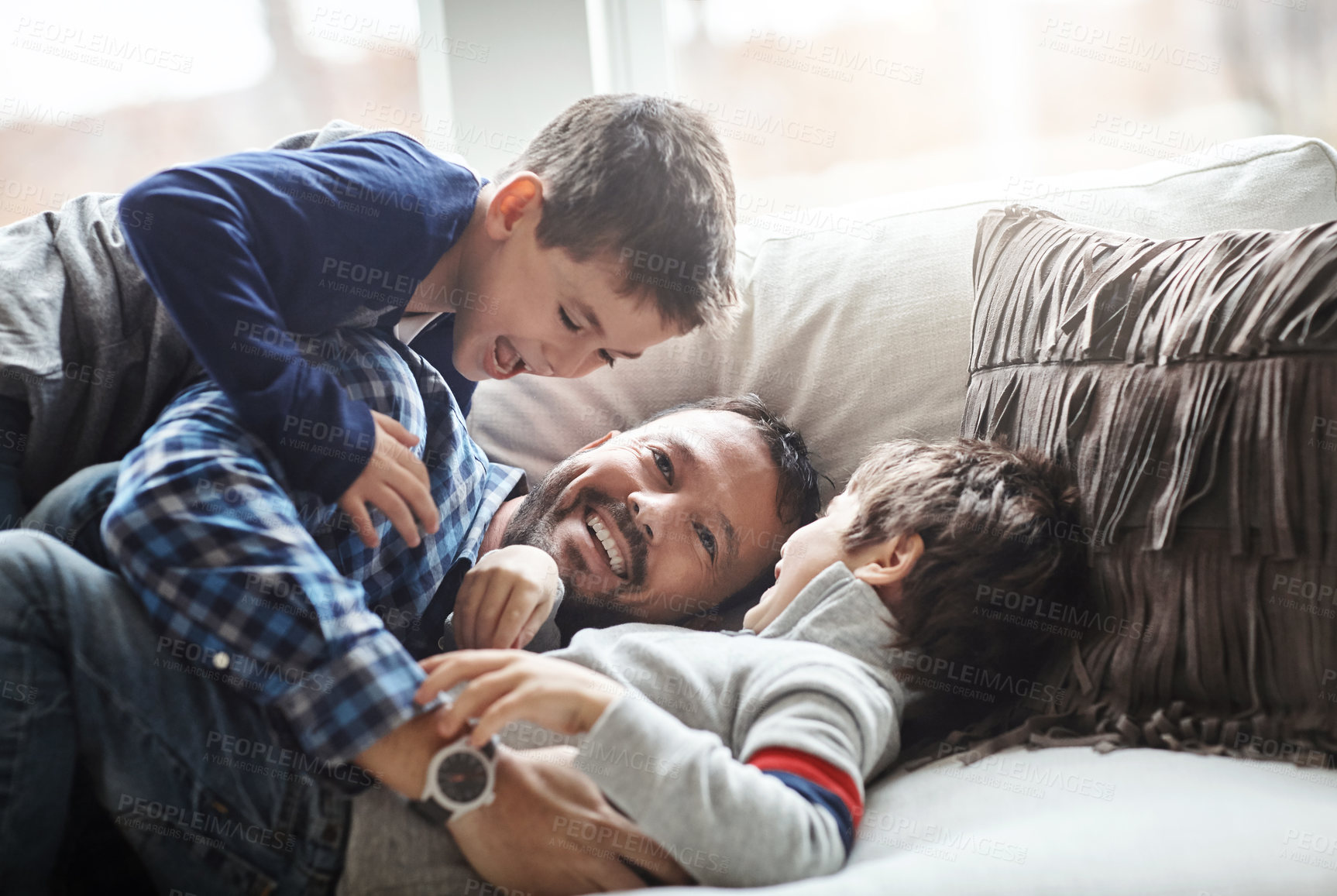 Buy stock photo Love, father and boys playing, sofa and bonding on weekend, loving or quality time together. Family, dad and male children being playful, relax or happiness on break, lounge or kids cheerful on couch