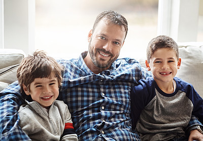 Buy stock photo Portrait of two adorable little boys relaxing with their father on the sofa at home
