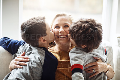 Buy stock photo Kiss, bonding and a mother with children for love, relax and playing in a family home together. Hug, smile and mom with affection for boy kids during quality time on the living room sofa of a house