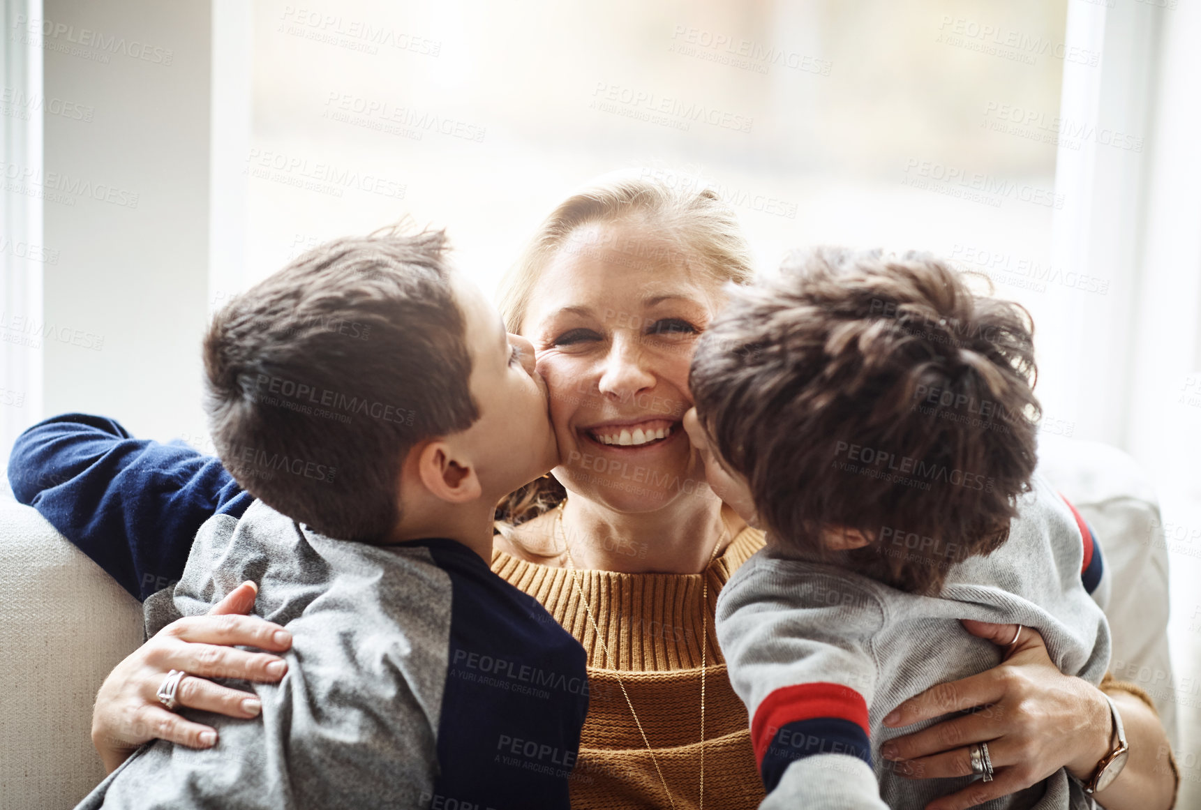 Buy stock photo Kiss, happy and portrait of a mother with children for love, relax and bonding in a family home. Hug, smile and mom with affection for boy kids during quality time on the living room sofa of a house