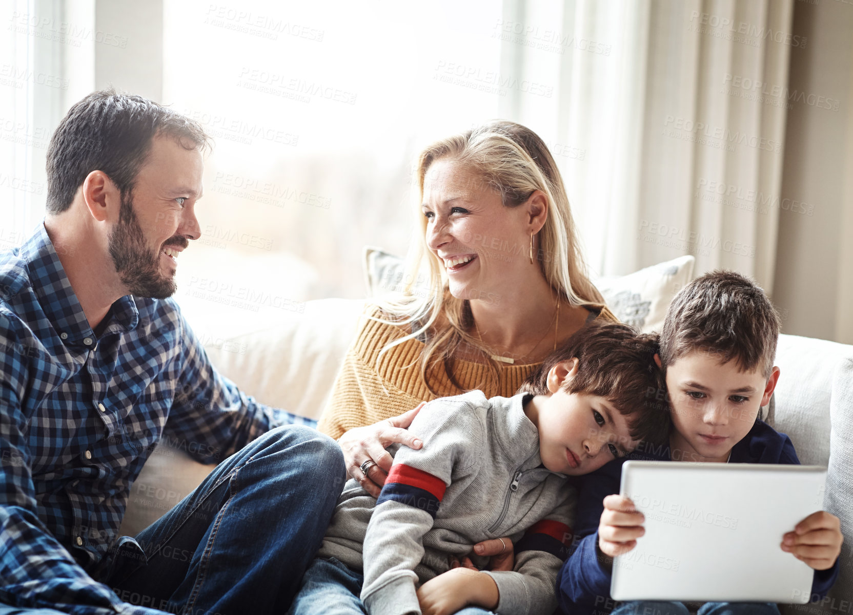 Buy stock photo Kids, parents and siblings with tablet on sofa for games streaming or movie search while bonding in their home. Happy family, love or people with children in living room for digital, learning or play