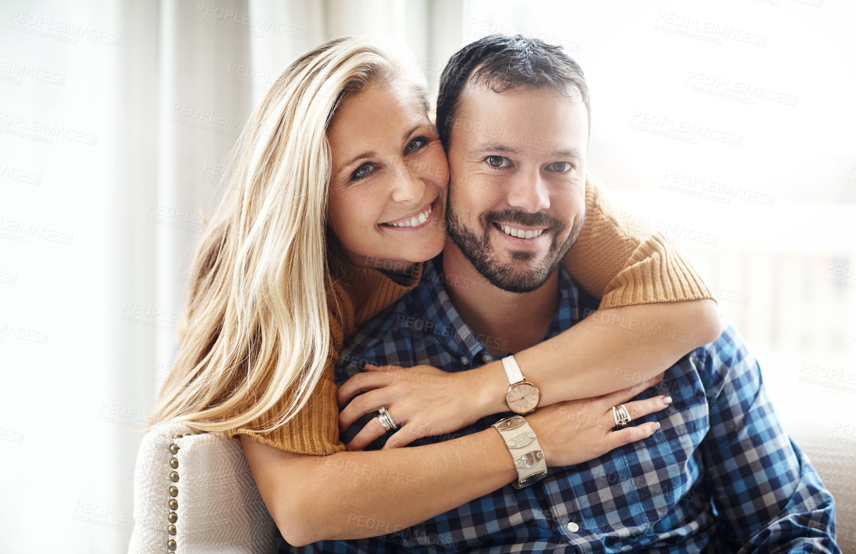 Buy stock photo Portrait of a happy couple relaxing on their living room sofa