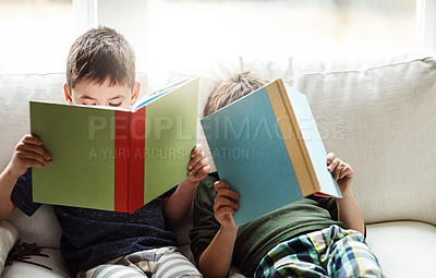 Buy stock photo Children, bonding and reading books for education, learning or relax studying on house living room in family home sofa. Kids, brothers and boys with storytelling, fairytale novels or fantasy fiction