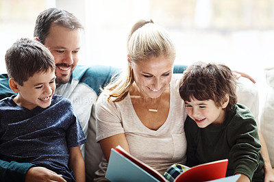 Buy stock photo Mom, dad and kids reading books on sofa for storytelling time with smile in happy family home. Love, learning and couple with children, book and fantasy story on couch, growth and child development.