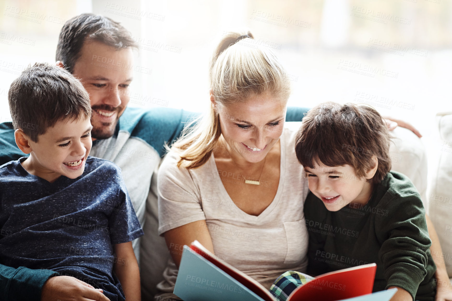 Buy stock photo Mom, dad and kids reading books on sofa for storytelling time with smile in happy family home. Love, learning and couple with children, book and fantasy story on couch, growth and child development.