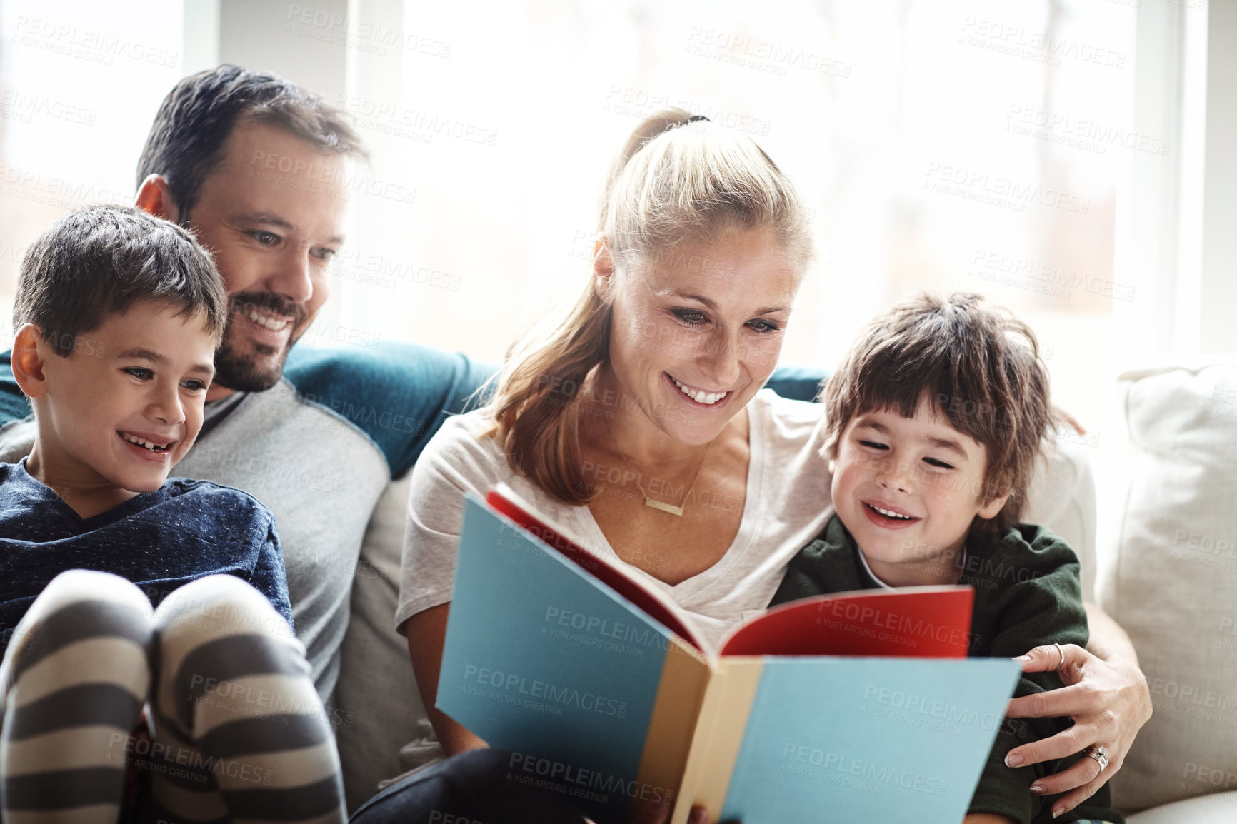 Buy stock photo Family, reading book together with parents and children, happiness at home with story time and learning. Love, relationship and happy people bonding in living room, education and mom, dad with kids