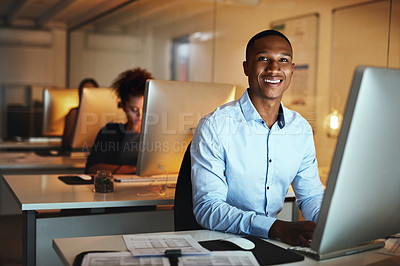 Buy stock photo Portrait of a young businessman working late on a computer in an office