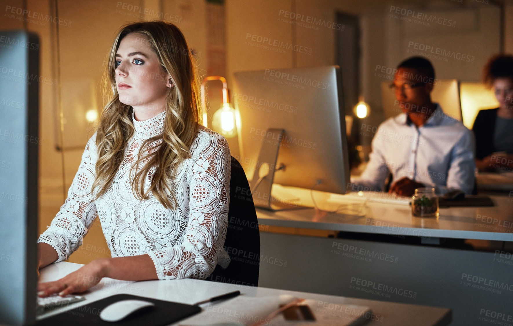 Buy stock photo Business woman, serious and night with computer for management or review in web design studio. Female person, tech and working late on project deadline for digital agency, coworking space and office