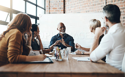 Buy stock photo Cropped shot of a mature businessman leading a meeting in the boardroom