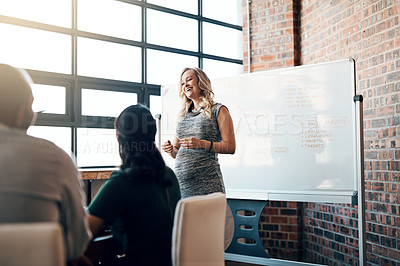 Buy stock photo Shot of a pregnant businesswoman giving a presentation in the boardroom