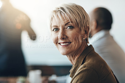 Buy stock photo Cropped portrait of a mature businesswoman sitting in the boardroom during a presentation