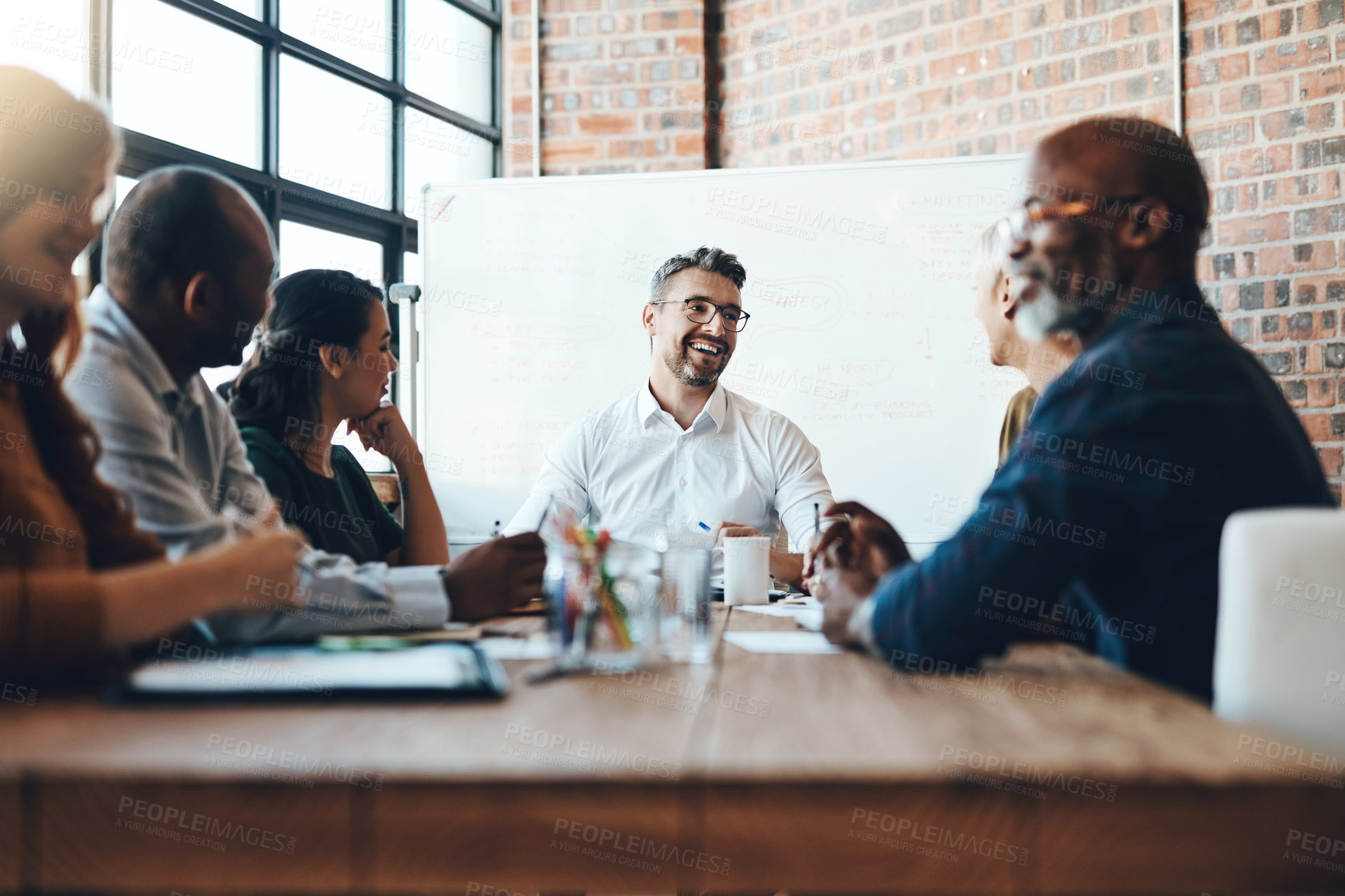 Buy stock photo Man, manager and business meeting in boardroom for financial growth with laughing at table. People, company and workshop with coach or speaker for corporate planning with team in happy office.