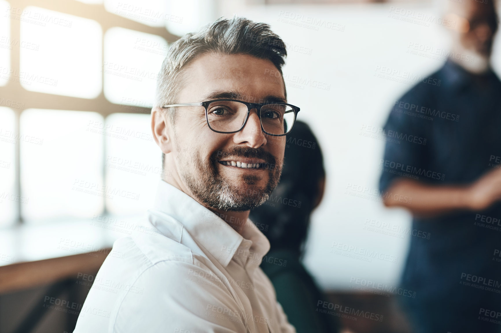 Buy stock photo Cropped portrait of a businessman sitting in the boardroom during a presentation