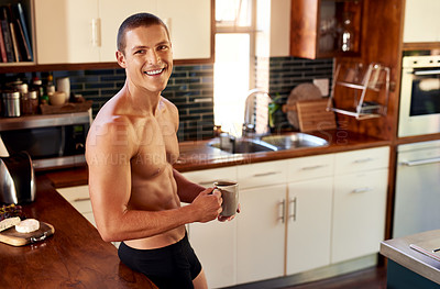 Buy stock photo Cropped shot of handsome young shirtless man drinking a cup of coffee in the kitchen at home