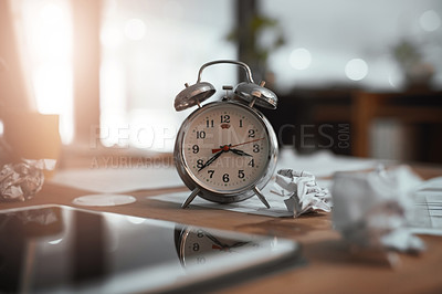 Buy stock photo Still life shot of a clock and crumpled paper on a desk in an office at night
