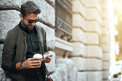 Buy stock photo Man, outdoor and happy with smartphone on wall with coffee in city for social media post and interaction. Male person, employee and smile or satisfied in New York with communication and networking