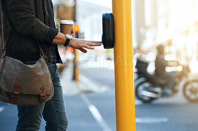 Buy stock photo Press, commute and man at crosswalk for road, traffic light and travel on street with outdoor pedestrian button. Signal, sign and hand of creative guy with coffee, downtown and walk in New York