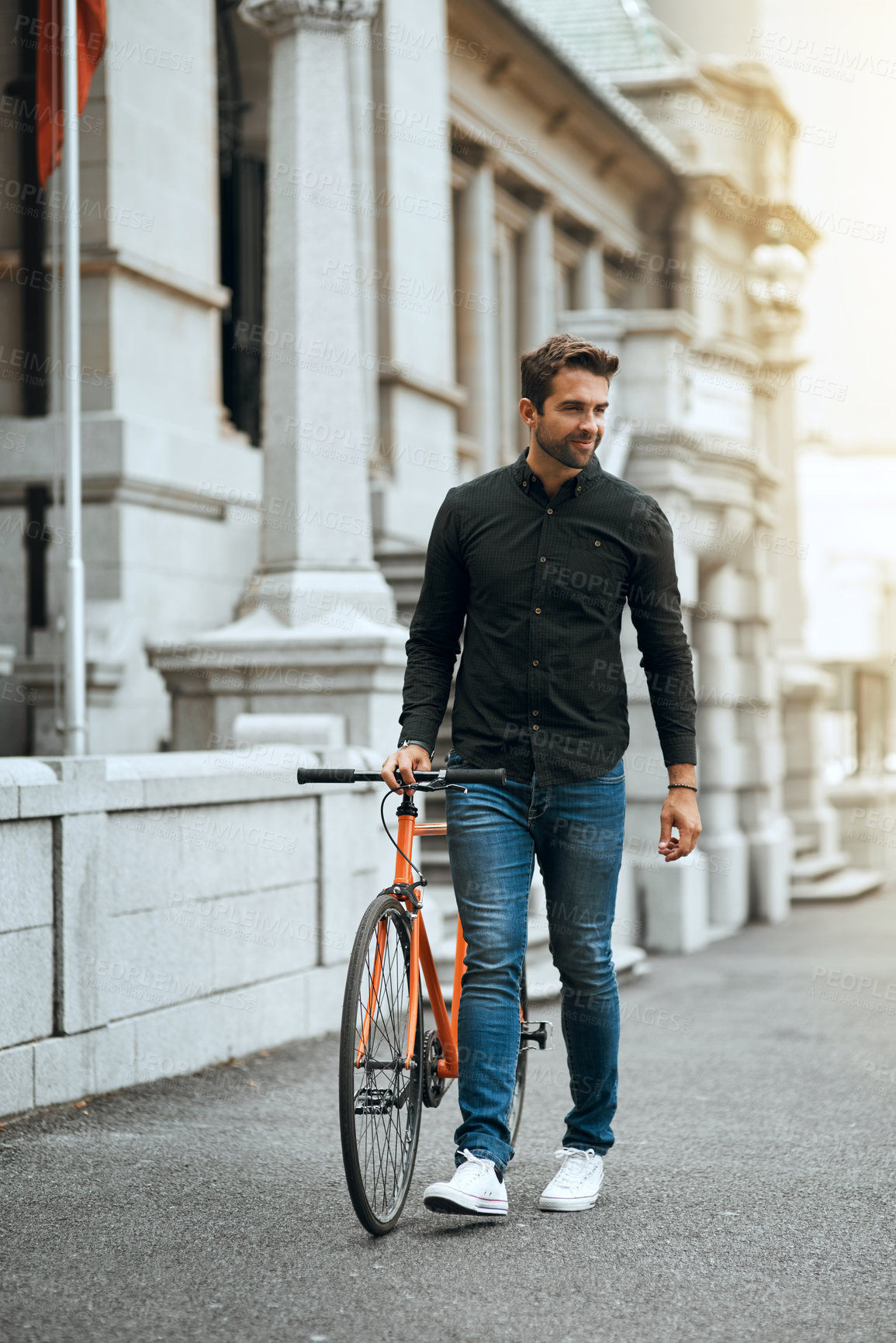 Buy stock photo Full length shot of a handsome young man traveling with his bike through the city
