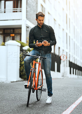 Buy stock photo Man, outdoor and serious with bicycle on smartphone in city for social media post and interaction. Male person, employee and texting online in New York with communication, networking and message