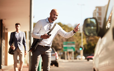 Buy stock photo Cropped shot of a handsome young businessman hailing a ride in the city