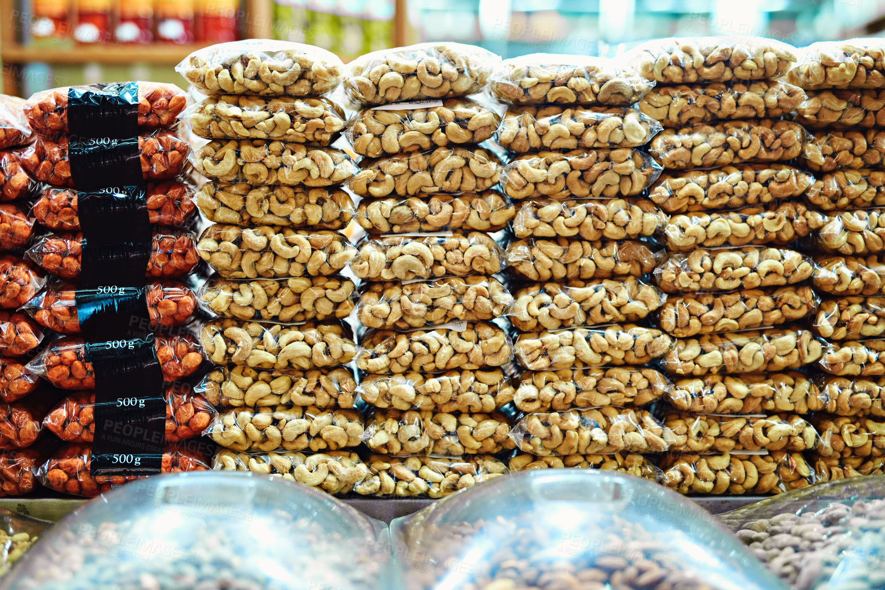 Buy stock photo Shot of packets full of nuts stacked on top of each other ready to be sold at a market during the day