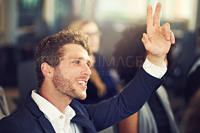 Buy stock photo Cropped shot of a handsome young businessman asking a question during a seminar