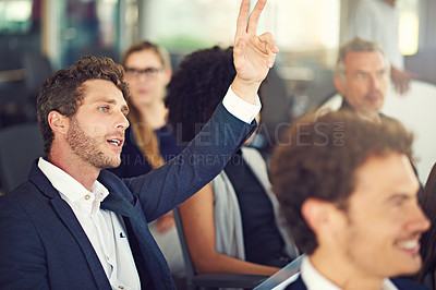 Buy stock photo Cropped shot of a handsome young businessman asking a question during a seminar