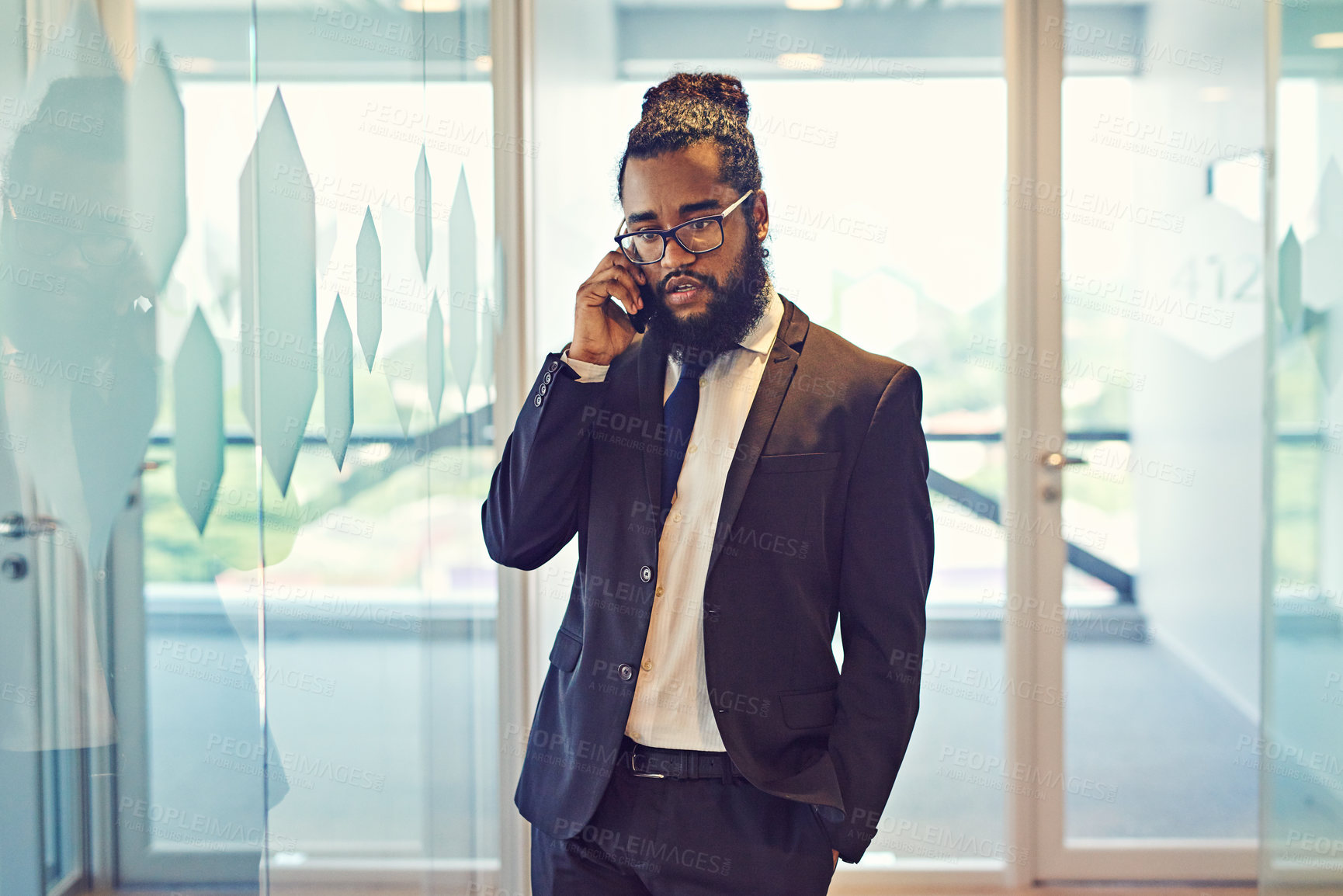 Buy stock photo Cropped shot of a handsome young businessman on call in a modern office