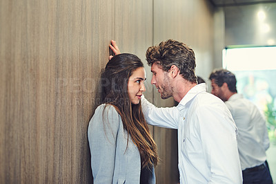 Buy stock photo Cropped shot of a businessman and businesswoman being affectionate in an elevator