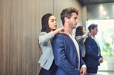 Buy stock photo Cropped shot of a businesswoman adjusting a businessman's collar in an elevator