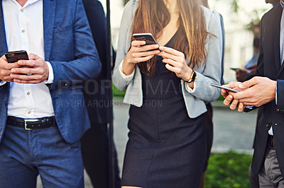 Buy stock photo Cropped shot of unrecognizable businesspeople using cellphones outside