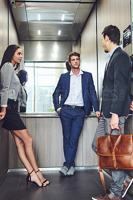Buy stock photo Shot of businesspeople in an elevator