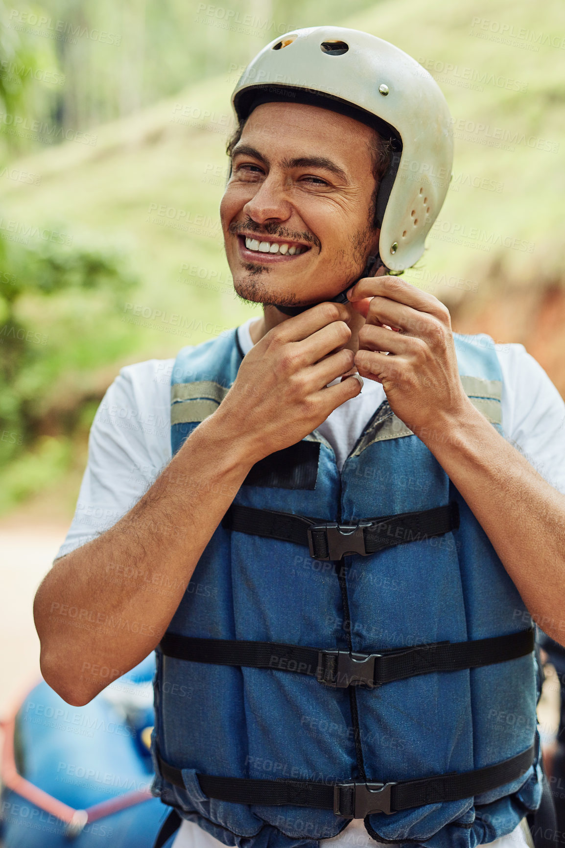 Buy stock photo Cropped shot of a young man adjusting his helmet